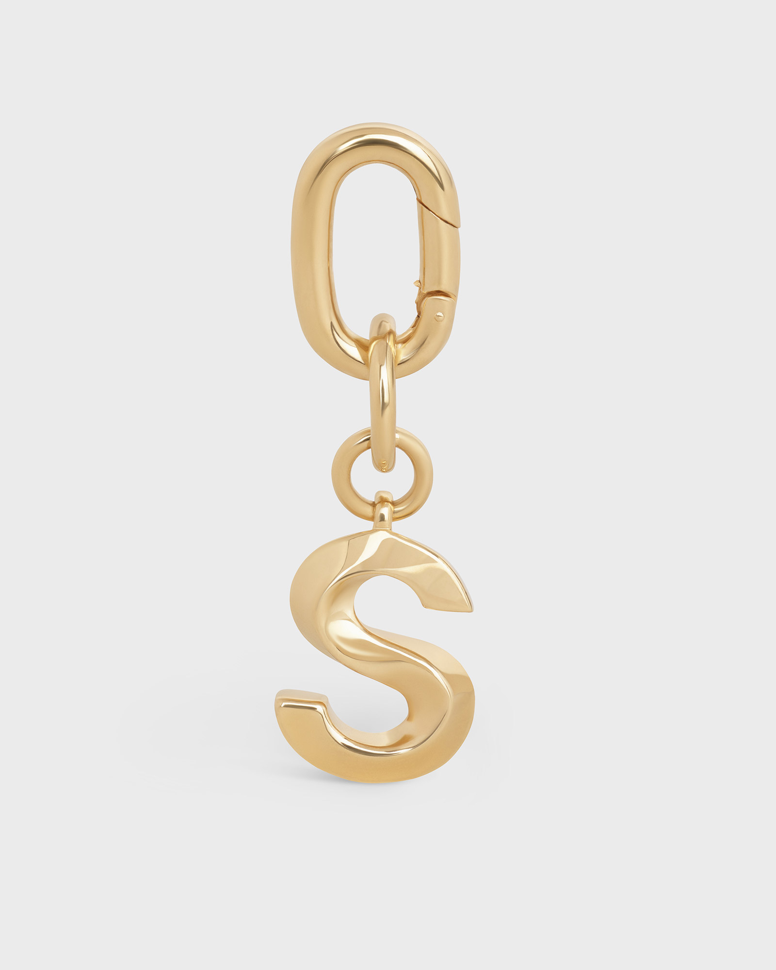 Perfectly retouched gold 'S' initial charm on a carabiner link, isolated on a white background for e-commerce product display.