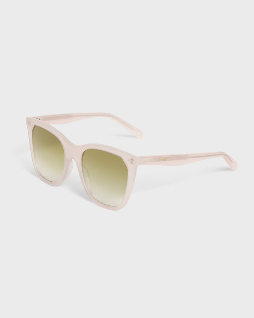 Side profile of square blush pink/nude acetate sunglasses with green-yellow gradient lenses, photographed on a light grey background for e-commerce.