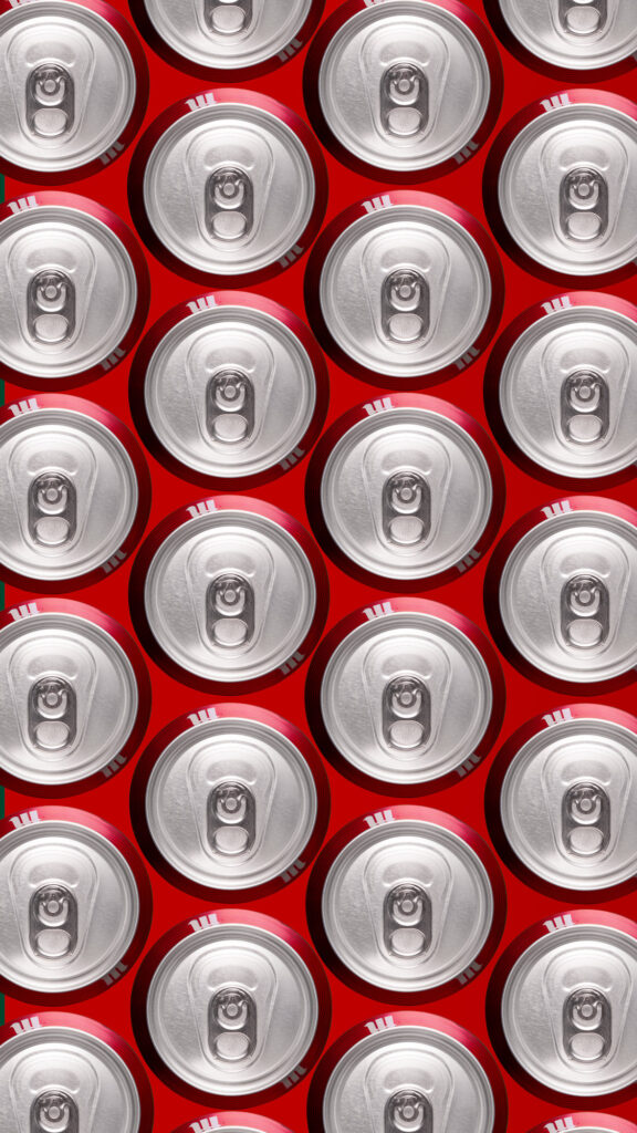 Seamless repeating pattern of silver aluminum beverage can tops with rings, set against a vibrant red background, shot directly from above for commercial use.